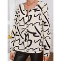 A flowing cream-colored ladies printed fashionable blouse with bold black abstract lines and long sleeves