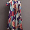 A woman wears a ladies retro casual high waist tunic shirt top with an abstract geometric pattern in bold tones
