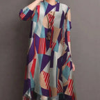 A woman wears a ladies retro casual high waist tunic shirt top with an abstract geometric pattern in bold tones