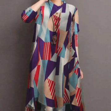 A woman wears a ladies retro casual high waist tunic shirt top with an abstract geometric pattern in bold tones