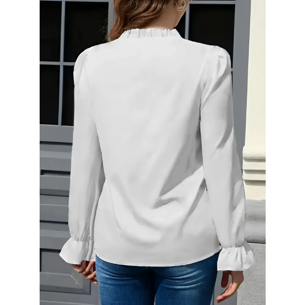 White ladies solid color blouse featuring a color lace collar and ruffled neckline with flared cuffs