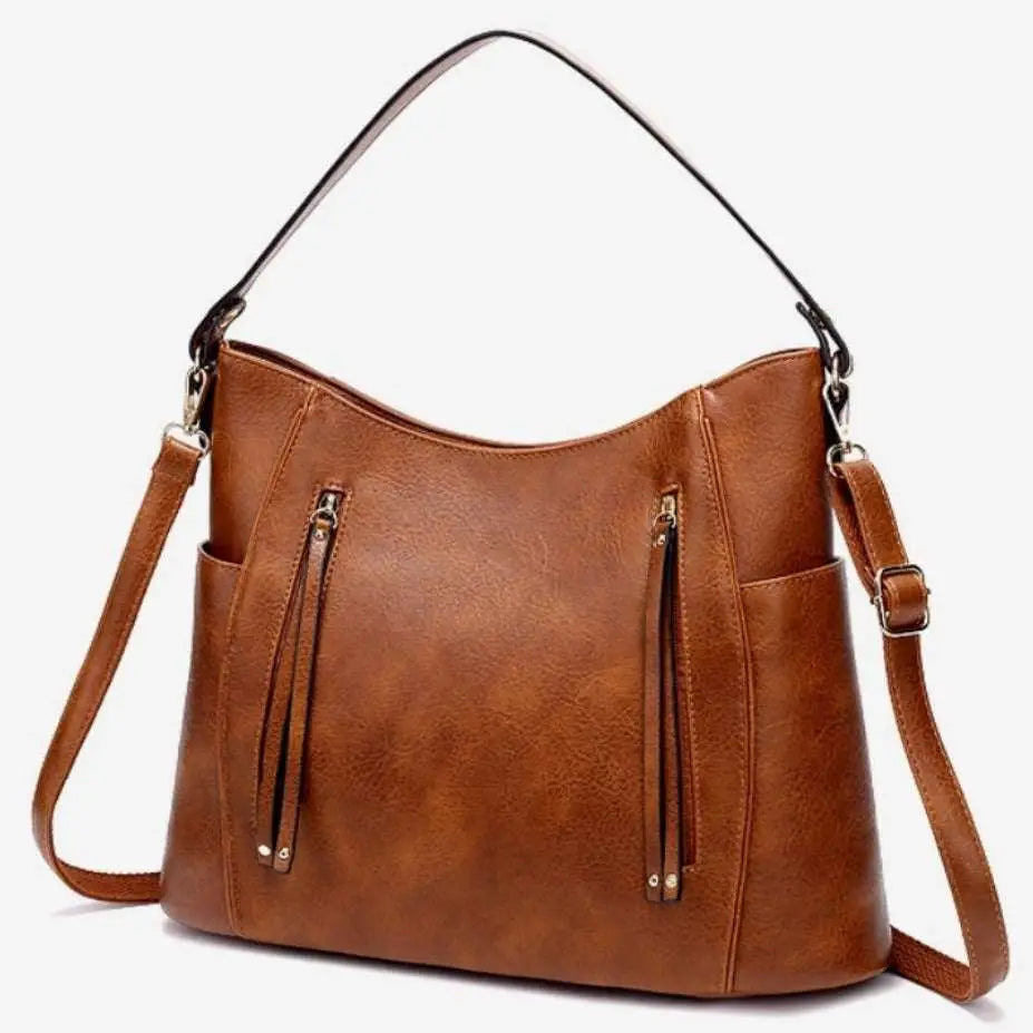 A sleek black luxury women leather hobo bag with large capacity tassel details and a detachable strap