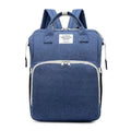 Blue denim textured large capacity mommy bag with white zipper pulls and front pocket for baby essentials