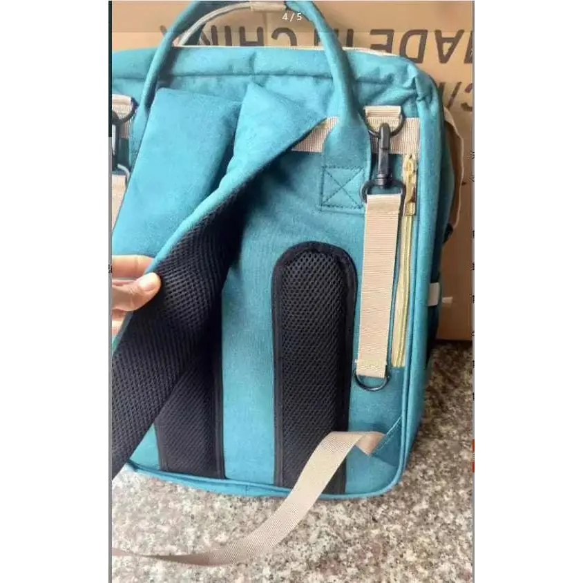 Teal large capacity mommy bag with black mesh panels and beige straps for baby essentials storage