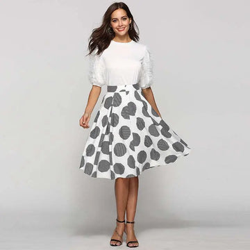 White slim fit a-line skirt with large polka dot round pattern and bold black and white striped detailing on dots