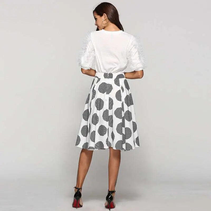 White dress with large polka dot black circular patterns and ruffled short sleeves in slim fit a-line style