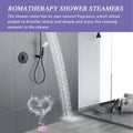 Pink cylindrical lavender aromatherapy shower tablets emitting heart-shaped mist with purple flowers and eucalyptus oil