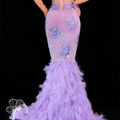 A shimmering lavender mermaid gown with diamond feather mesh detailing and a voluminous feathered train