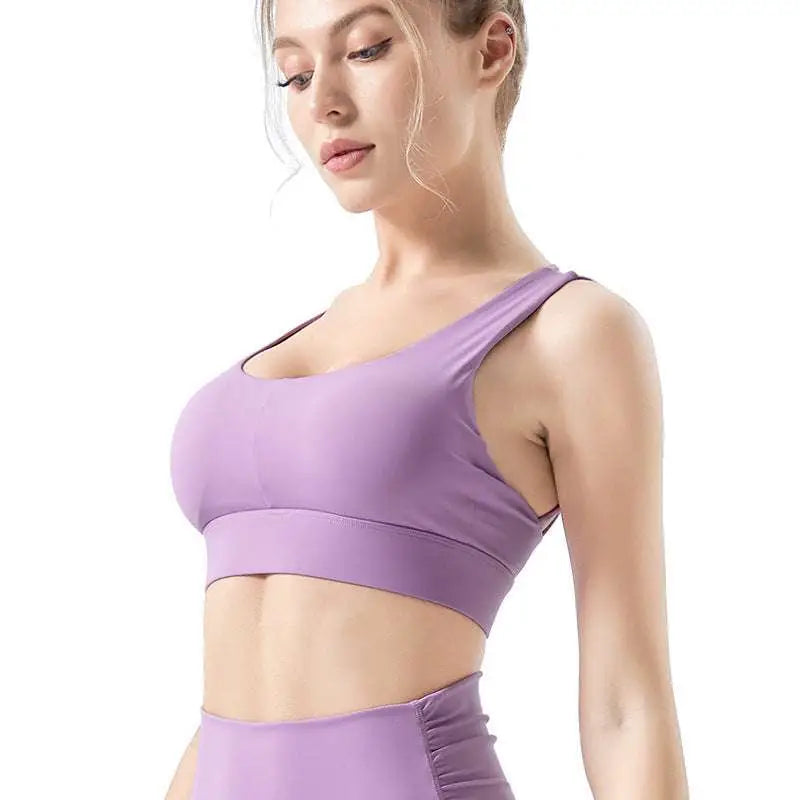 Lavender fitness bra with nylon fabric features thin straps and a supportive band for strappy and seamless support