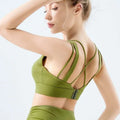 Back view of olive green strappy seamless fitness bra with crisscross design made from nylon in lavender fitness bra line