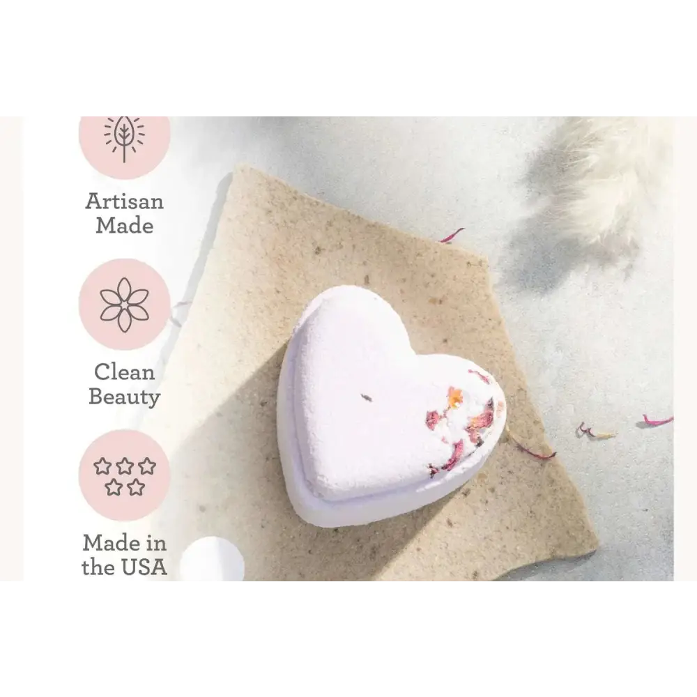 A soft lavender heart shower steamer with delicate dried flower petals in a shower steamers gift set