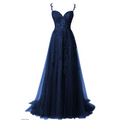 A navy blue evening gown with lace detailing and bows combines elegance and charm for red carpet runway events