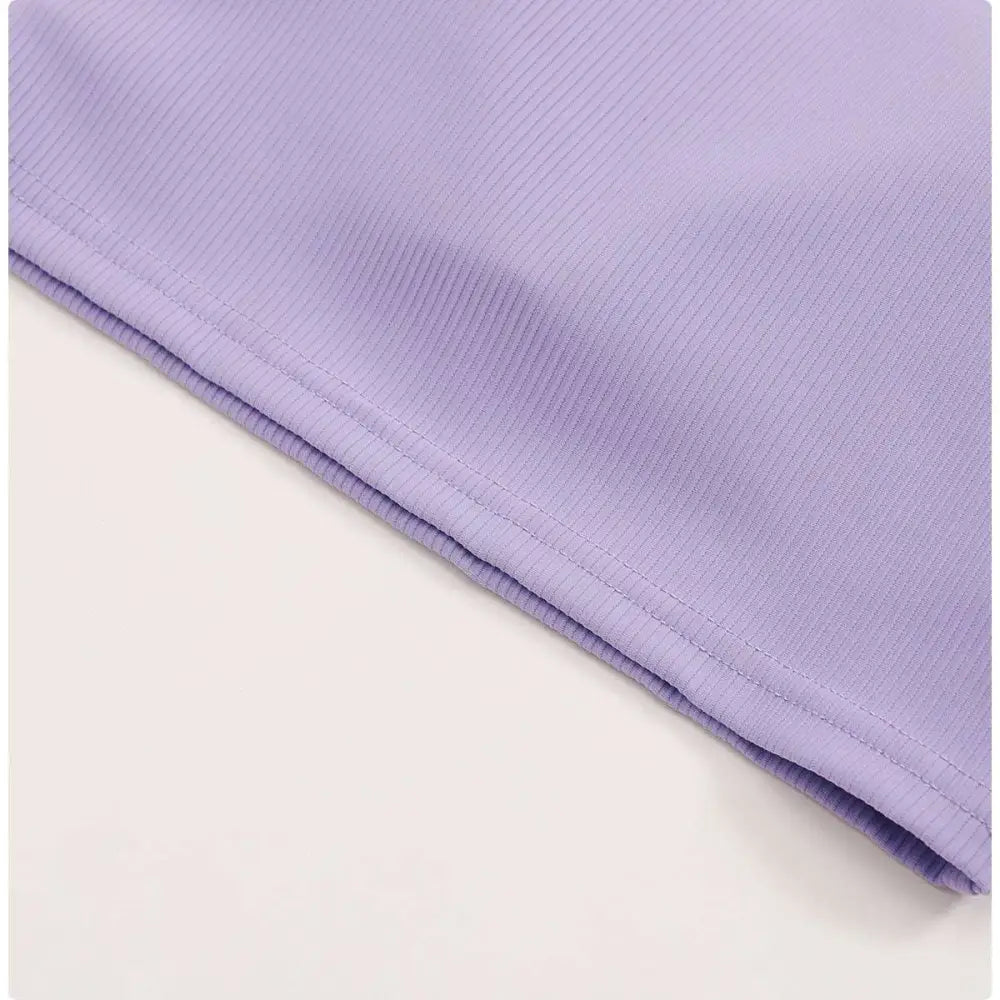 A breathable running sports bra in soft lavender ribbed fabric with subtle texture and a neatly stitched hem