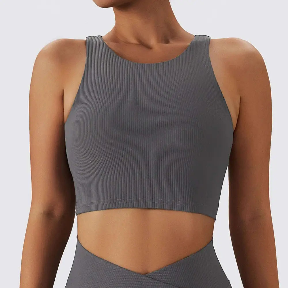 Gray ribbed crop top with shoulder straps and round neckline designed as a breathable running sports bra