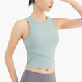 A light mint green ribbed sleeveless fitness vest with chest pad and crossed panel detailing for activewear use