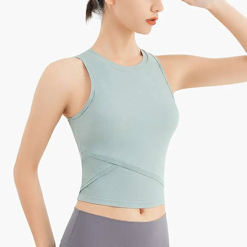 A light mint green ribbed sleeveless fitness vest with chest pad and crossed panel detailing for activewear use