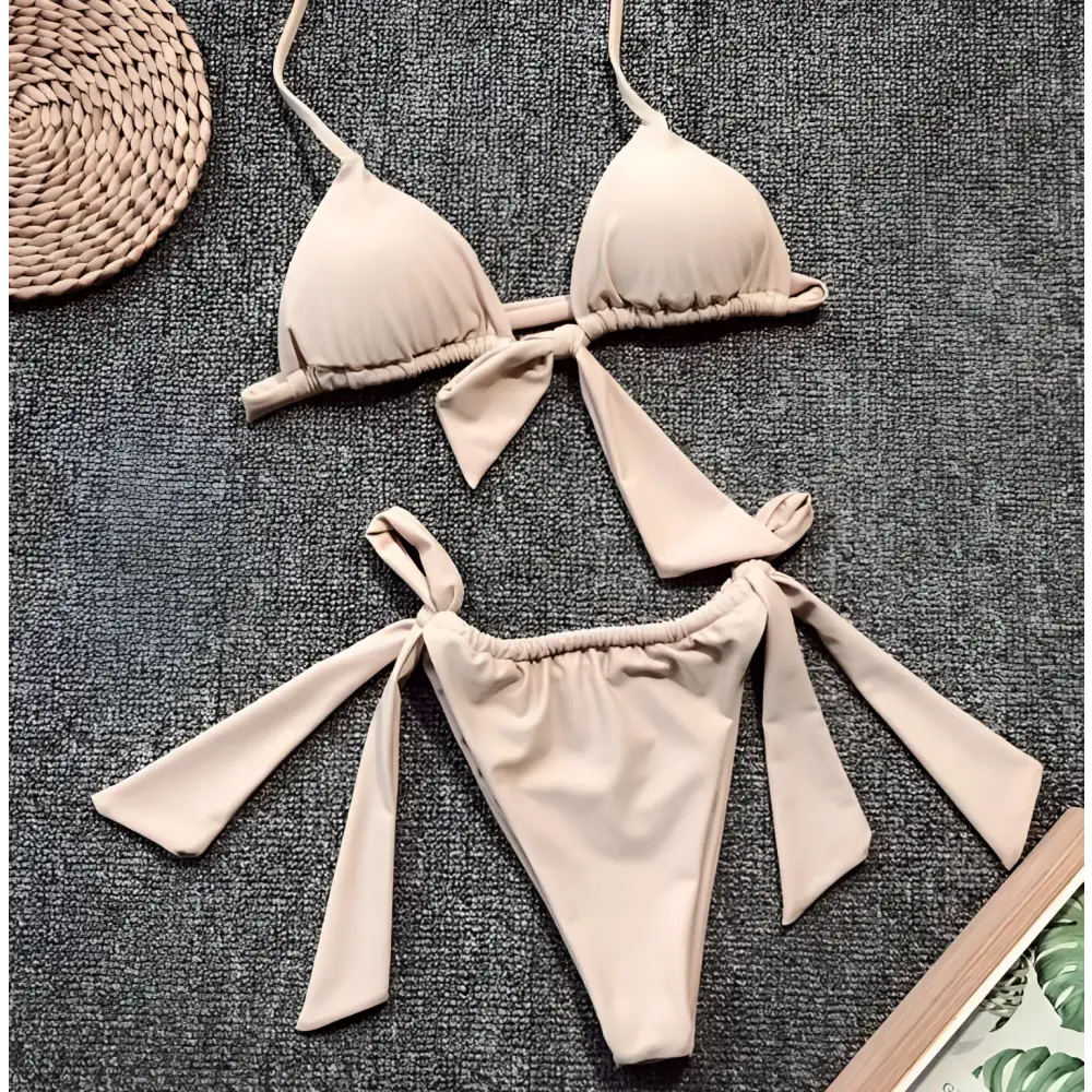 Lavender ruched triangle split bikini swimsuit with tied bow details on top and bottom pieces for beachwear