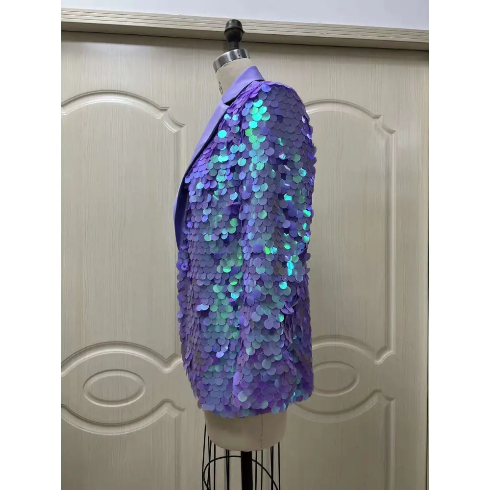 A lavender sequin fashion suit blazer with iridescent blue and green highlights on a mannequin for high dinner party
