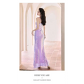 A shimmering lavender sequined evening mermaid gown with a fitted silhouette thin straps and a high slit