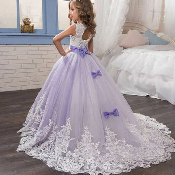 Lavender tulle lace wedding dress for children featuring white lace detailing and matching bows in lavender tulle lace fabric