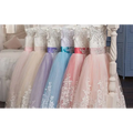 A row of sleeveless lavender tulle lace wedding dress and pastel light blue clothing with white lace detailing