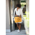 Bright yellow leather leader laptop bag with black trim and top handles featuring a shoulder strap design