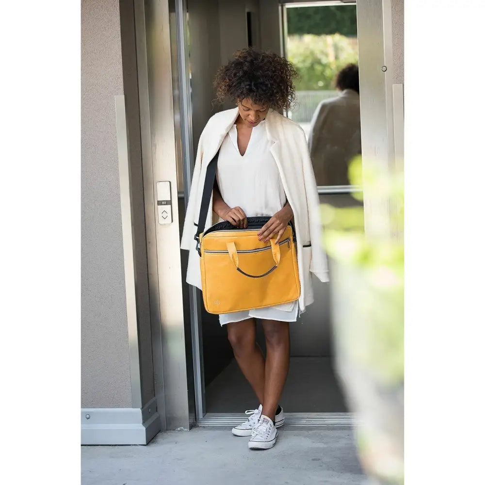 Bright yellow leather leader laptop bag with black trim and top handles featuring a shoulder strap design