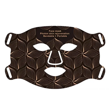 Brown face mask with leaf pattern and white cutouts for eyes nose and mouth skin texture rejuvenation beauty apparatus