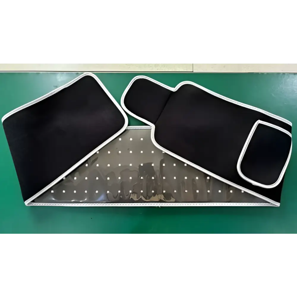 Black fabric led infrared belt therapy device with white stitched edges and perforated metal panel for infrared heating red