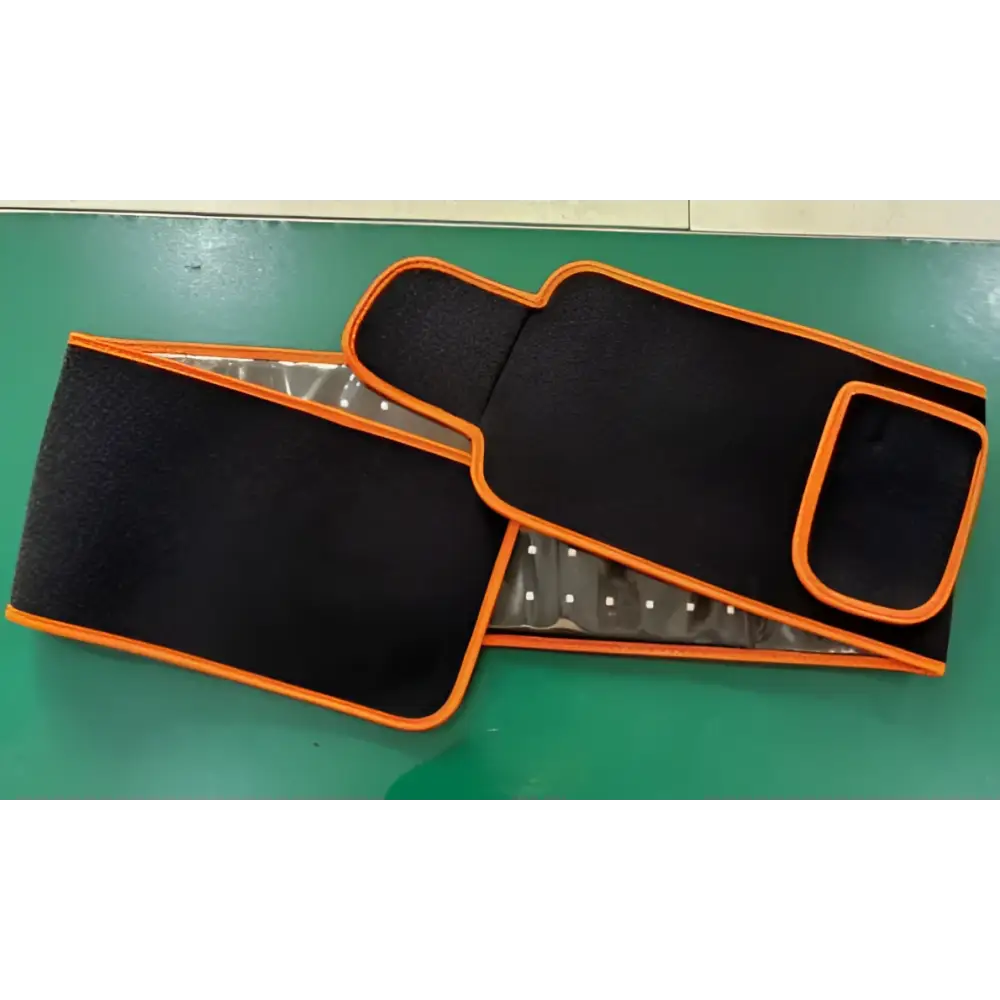 Black and orange led infrared belt therapy device with textured fabric exterior and visible infrared heating red elements inside