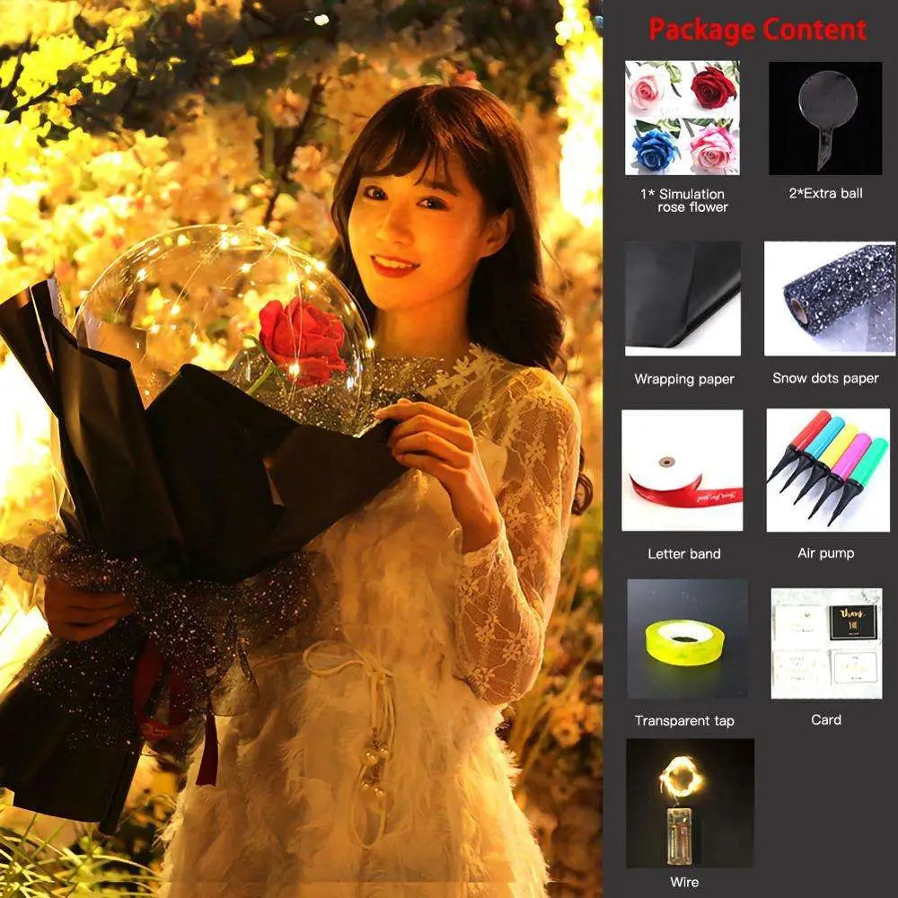 A transparent bobo ball luminous balloon rose filled with warm fairy lights and a single red simulation rose flower