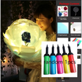 A glowing translucent spherical transparent bobo ball with a black simulation rose in a luminous balloon rose bouquet