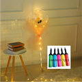 A luminous balloon rose bouquet featuring a glowing transparent bobo ball with a yellow rose and orange organza ribbon