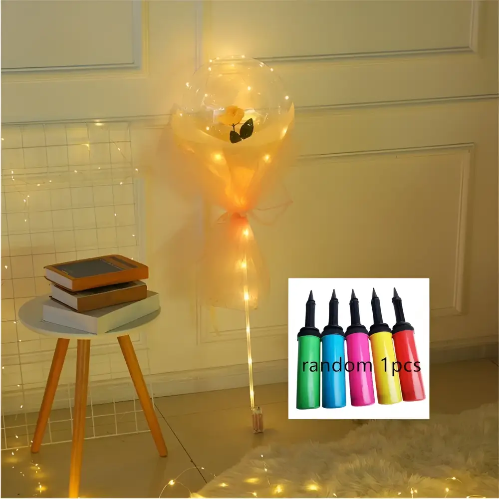 A luminous balloon rose bouquet featuring a glowing transparent bobo ball with a yellow rose and orange organza ribbon