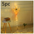 A luminous balloon rose bouquet featuring a yellow rose inside a transparent bobo ball with peach organza ribbon