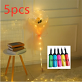 A glowing transparent bobo ball luminous balloon rose bouquet with yellow flower design wrapped in orange tulle with led lights