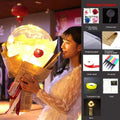 A glowing transparent bobo ball luminous balloon rose bouquet with a red rose wrapped in newspaper and ribbon