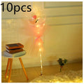 A luminous balloon rose bouquet with a pink rose inside a transparent bobo ball wrapped in peach organza