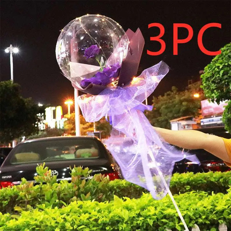 Transparent bobo ball luminous balloon rose bouquet featuring a single purple rose wrapped in sheer lavender tissue paper