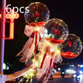 Clear spherical transparent bobo ball luminous balloon rose bouquet with red roses and glowing fairy lights inside