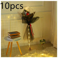 A luminous balloon rose bouquet featuring a single red rose inside a transparent bobo ball wrapped in black tulle with lights