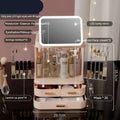 Pastel pink multi-tiered cosmetics storage box with built-in cosmetic mirror and clear acrylic compartments