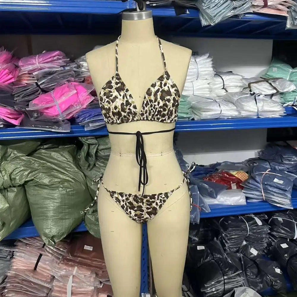 Leopard print breathable strap bikini swimsuit featuring a triangle top and matching bottoms with black waist ties