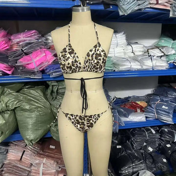 Leopard print breathable strap bikini swimsuit featuring a triangle top and matching bottoms with black waist ties