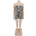Strapless leopard print jumpsuit plus size with fitted bodice and shorts featuring black and tan spots on white base