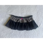 Black leopard print sexy hot girl skirt with ruffled velvet hem and delicate lace trim for stylish wear