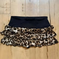 A black and leopard print ruffled mini hot girl skirt with a stretchy waistband and lace trim detail