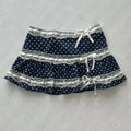 A navy blue polka dot mini hot girl skirt with white lace trim and matching ribbon bows for a leopard print sexy look