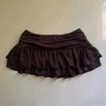 A dark brown two-tiered ruffle skirt with gathered waistband featuring lace trim in a leopard print sexy hot girl skirt style