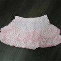 A soft pink and white polka dot ruffled hot girl skirt with lace trim and a flowing design for leopard print sexy looks